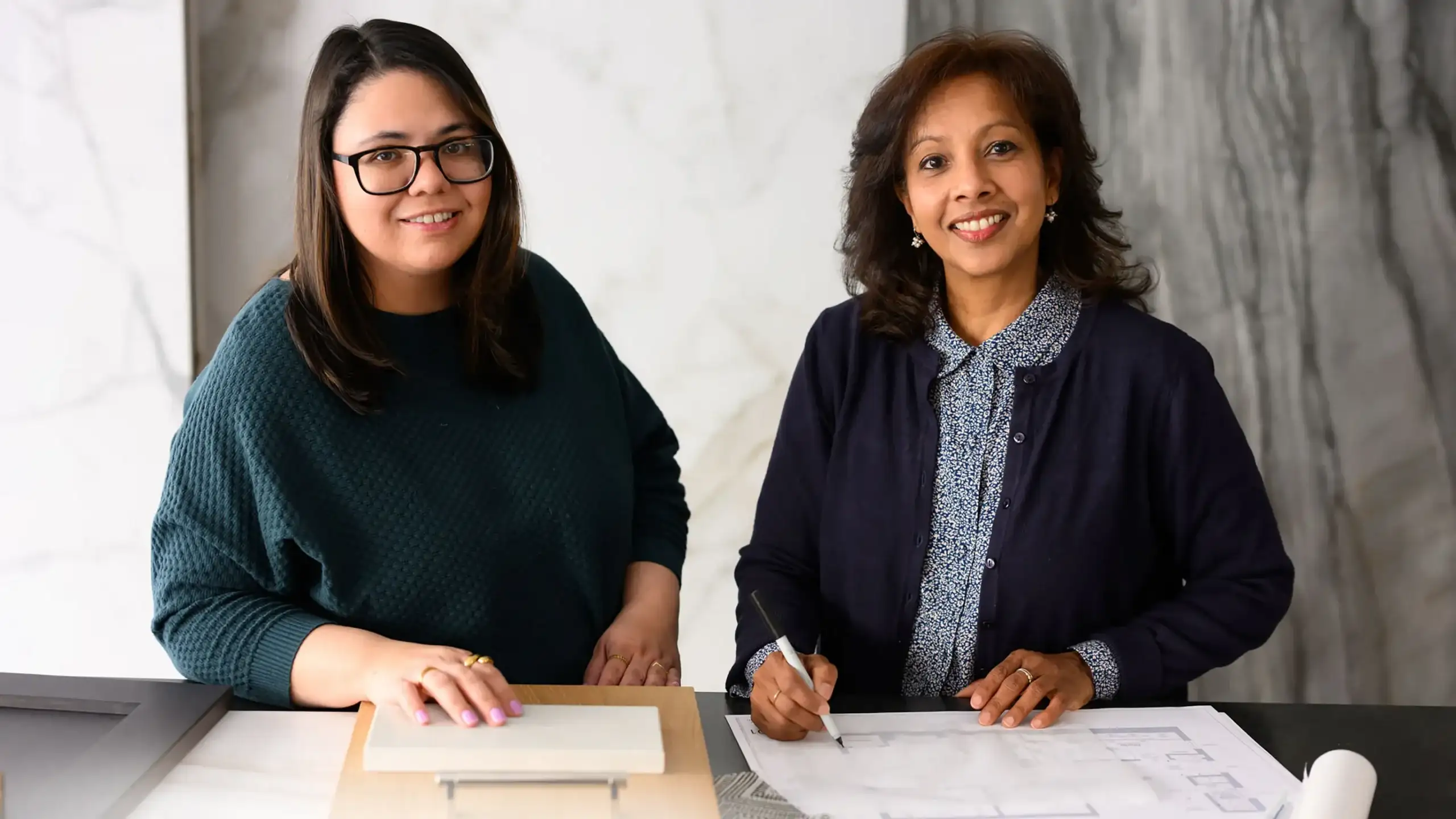 Every Home Has a Story Two AIDAN Design employees collaborating on a DC home design project
